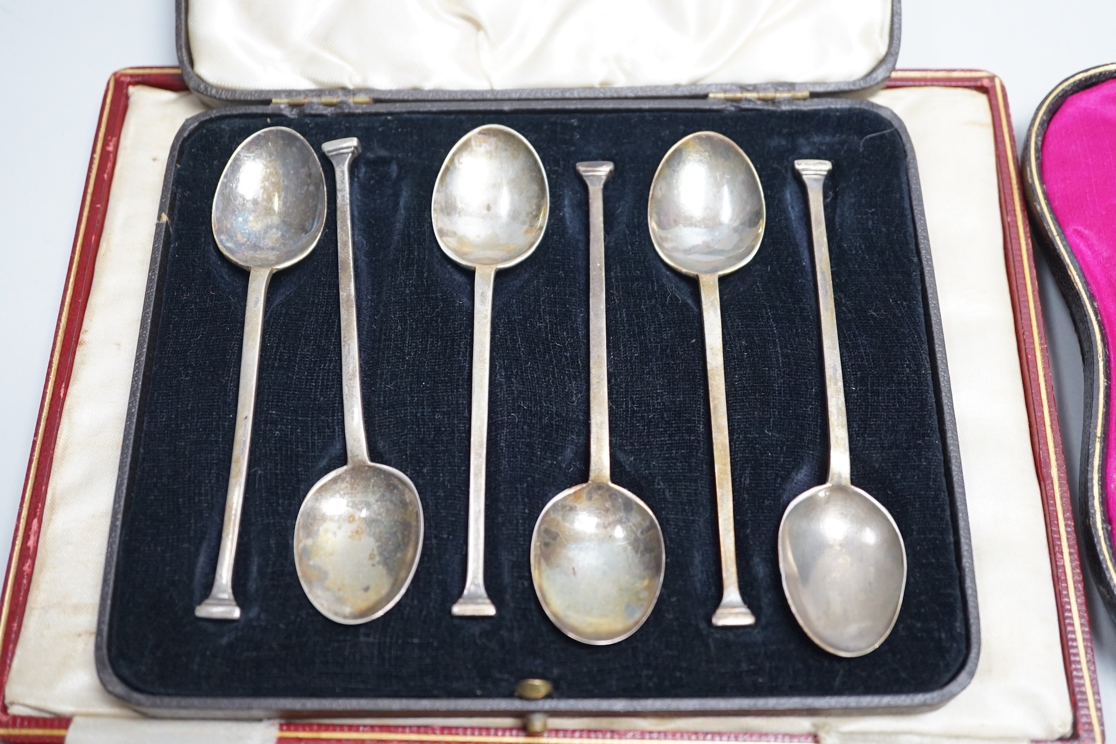 A set of six teaspoons, London, 1910, a set of six silver coffee spoons, six silver handled tea knives, all cased.